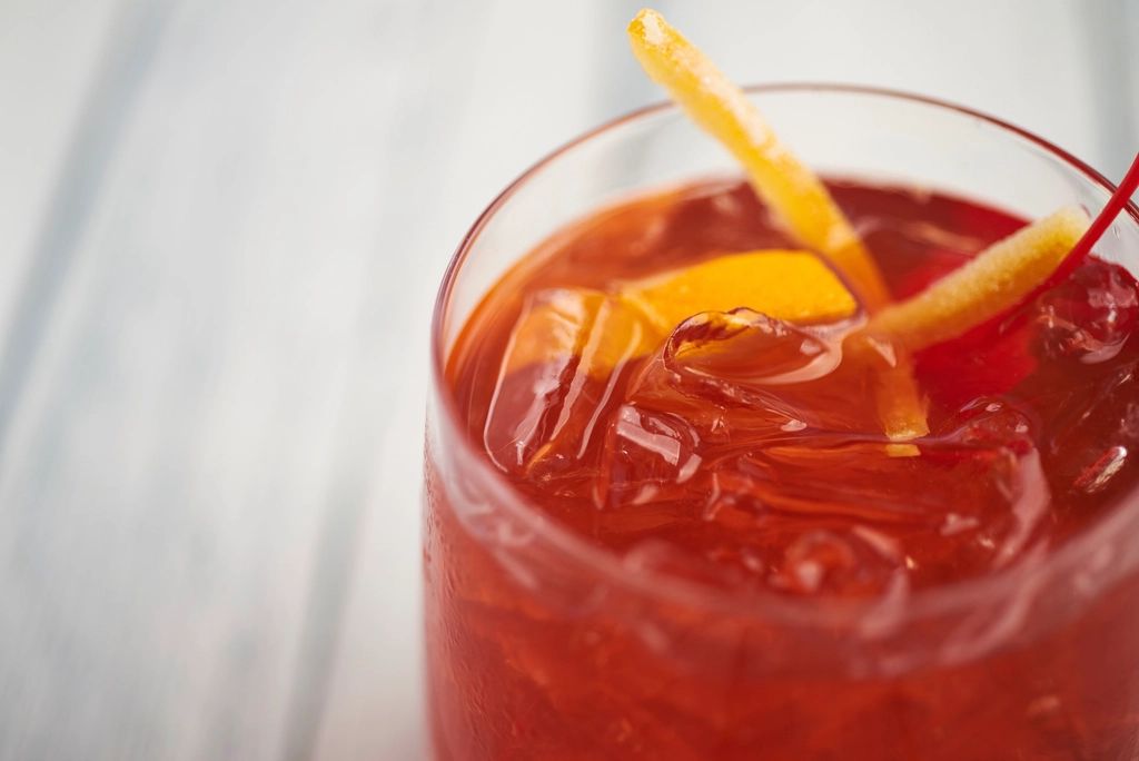 A cocktail being finished at the bar